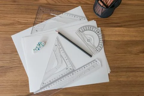 Measuring and drawing tools. A sheet of white paper, pencils, rulers on the desk Stock Photos