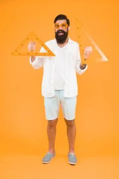 Measuring angles at geometry. Geometry teacher holding triangles for school Stock Photos