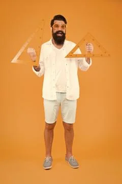 Measuring angles at geometry. Geometry teacher holding triangles for school Stock Photos