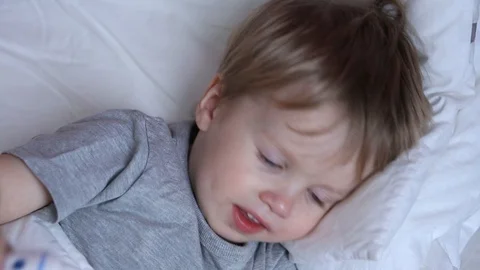 Measuring baby's temperature with contactless digital infrared thermometer Stock Footage 93865111