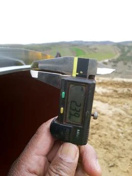 Measuring the beveling dimensions of the end pipe with a caliper Stock Photos