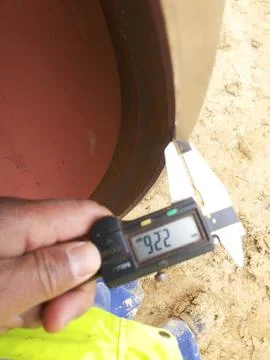 Measuring the beveling dimensions of the end pipe with a caliper Stock Photos