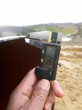 Measuring the beveling dimensions of the end pipe with a caliper Stock Photos