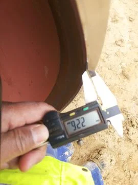 Measuring the beveling dimensions of the end pipe with a caliper Stock Photos