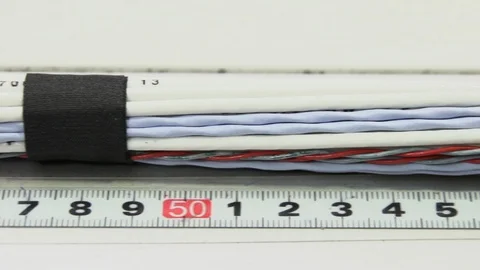 Measuring cable against ruler Stock Footage 91841842