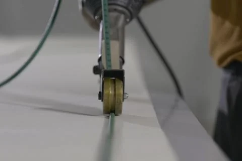 Measuring cable on roller, measuring the workpiece web. Stock Photos