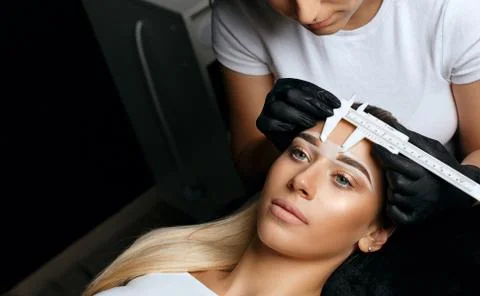 Measuring with calipers before permanent makeup Fotos Stock