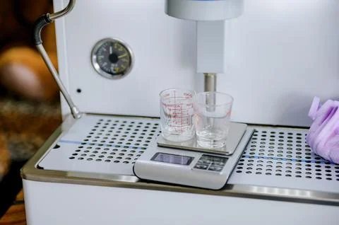 Measuring coffee with a scale.Measuring coffee affects the taste and aroma. Stock Photos