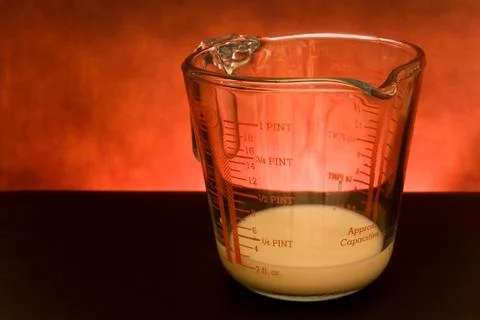 Measuring cup with milk Фото