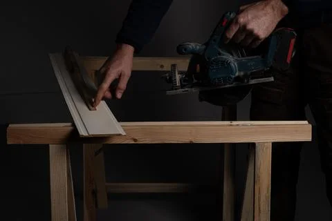 Measuring decorative wall panel board before cutting with circular saw Stock Photos