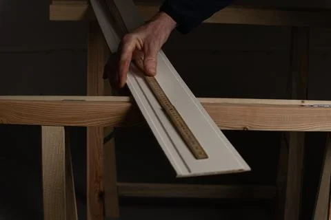 Measuring decorative wall panel board with folding ruler before cutting in .. Stock Photos