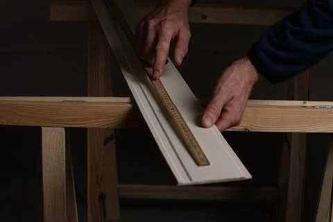 Measuring decorative wall panel board with folding ruler before cutting Stock Photos