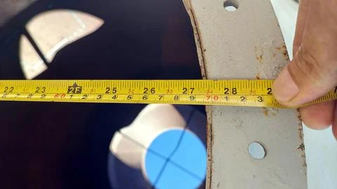 Measuring the Diameter of a Circular Object With a Tape Measure Stock Photos