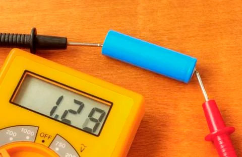 Measuring with digital multimeter of rechargeable battery Stock Photos