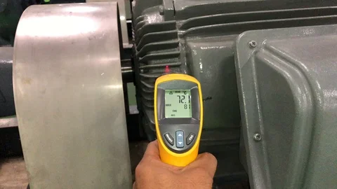 Measuring electrical motor temperature by Infrared Laser Thermometer Stock Footage 97653113
