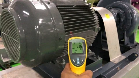 Measuring electrical motor temperature by Infrared Laser Thermometer Stock Footage 97653137