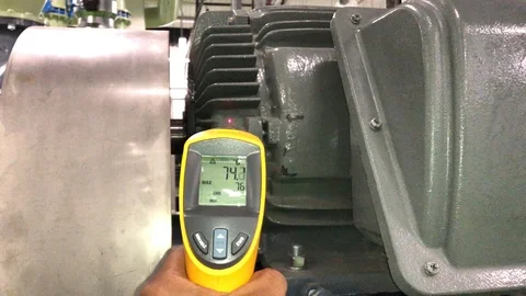 Measuring electrical motor temperature by Infrared Laser Thermometer Stock Footage 97653152