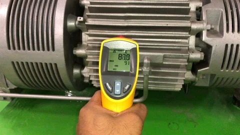 Measuring electrical motor temperature by Infrared Laser Thermometer Stock Footage 97710392
