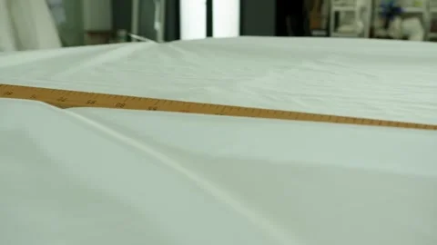 Measuring fabric length in a workshop for sewing projects Stock Footage 313213897
