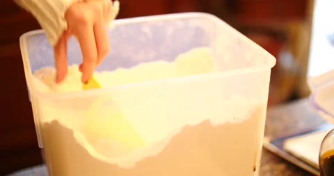 Measuring flour into a measuring cup scooping up ingredient close-up Video stock 217356177