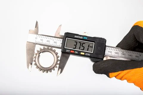Measuring the gears with a caliper. Engineering work in the laboratory. Stock Photos