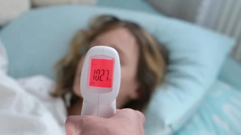 Measuring a high temperature of body Stock Footage 331597258