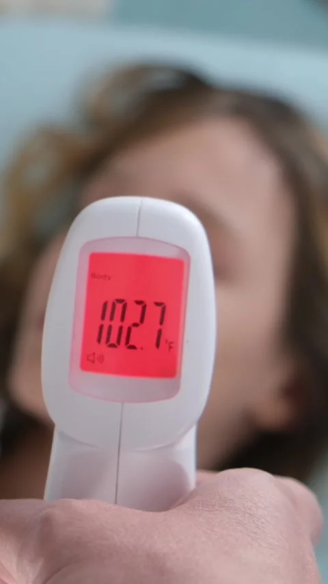Measuring a high temperature of body Stock Footage 331659237