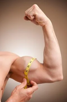 Measuring his bicep Stock Photos
