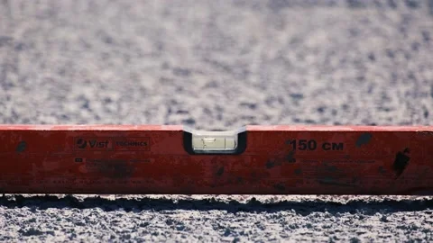 Measuring horizontal floor level of concrete roof with spirit bubble level tool. Video stock 157143242