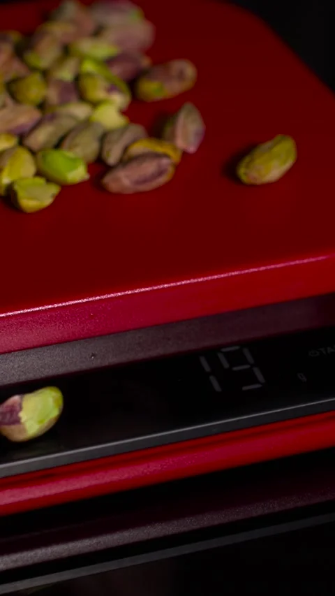 Measuring ingredients on a kitchen scale for precise cooking and baking Stock Footage 316860253