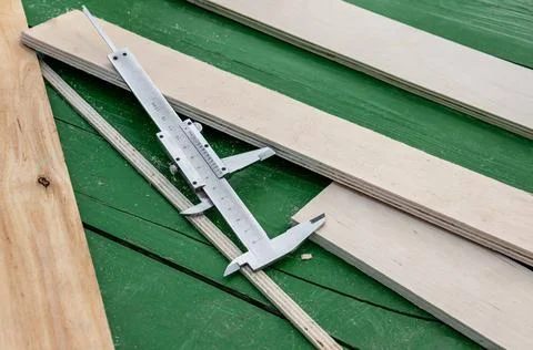 Measuring instrument is lying on the table among the boxes. Production of woo Stock Photos