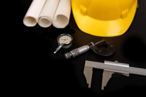 Measuring instruments, helmet and documents. Accessories for an engineer on a Stock Photos