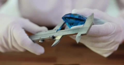 Measuring large blue diamond in hands of gemologist Stock Footage 251737503