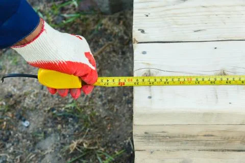 Measuring the length with a construction tape. Stock Photos