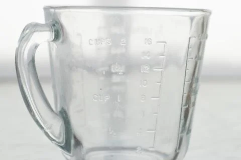 Measuring mug on a white background Stock Photos
