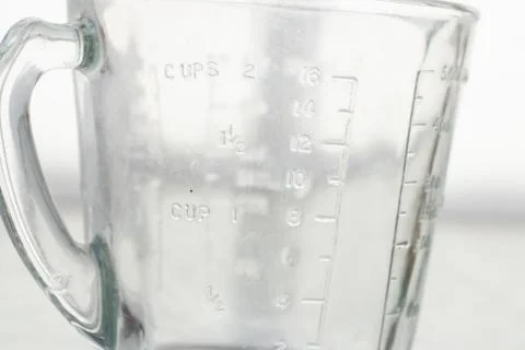 Measuring mug on a white background Stock Photos