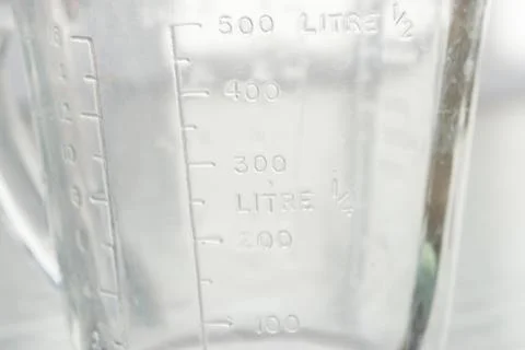 Measuring mug on a white background Stock Photos