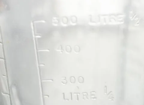Measuring mug on a white background Stock Photos