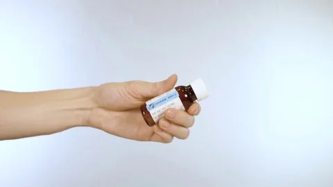 Measuring out liquid medication with shake well label Stock Footage 72163384