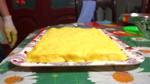 Measuring the portions of a rectangular shaped Causa with a knife Stock Footage 146001572