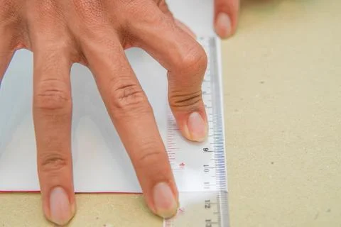 Measuring. Ruler. Image of a hand in the act of measuring with a ruler Stock Photos