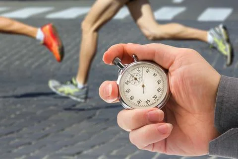 Measuring the running speed of an athlete using a mechanical stopwatch. hand  Stock Photos