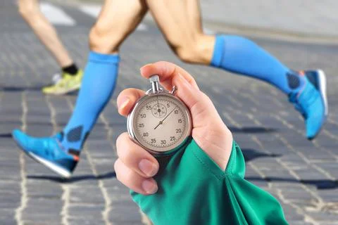 Measuring the running speed of an athlete using a mechanical stopwatch. hand  Stock Photos