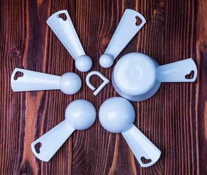 Measuring set table spoons and cups plastic white color on woode Stock Photos