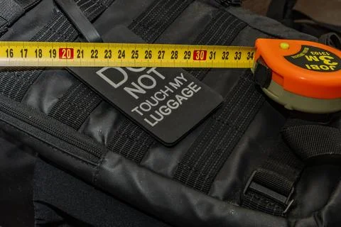 Measuring the size of a backpack with a tape measure, the maximum size of h.. Stock Photos