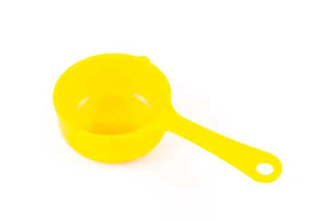 Measuring spoon or cup over the white background. Stock Photos