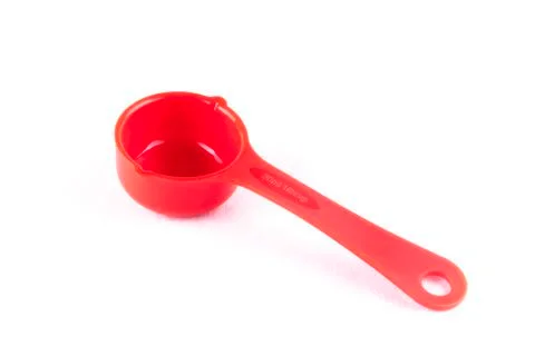 Measuring spoon or cup over the white background. 写真素材