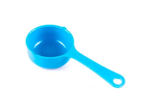 Measuring spoon or cup over the white background. Stock Photos