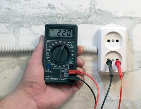 Measuring supply voltage digital multimeter Stock Photos