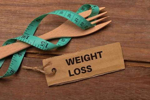 Measuring tap, fork and memo note written with WEIGHT LOSS Stock Photos